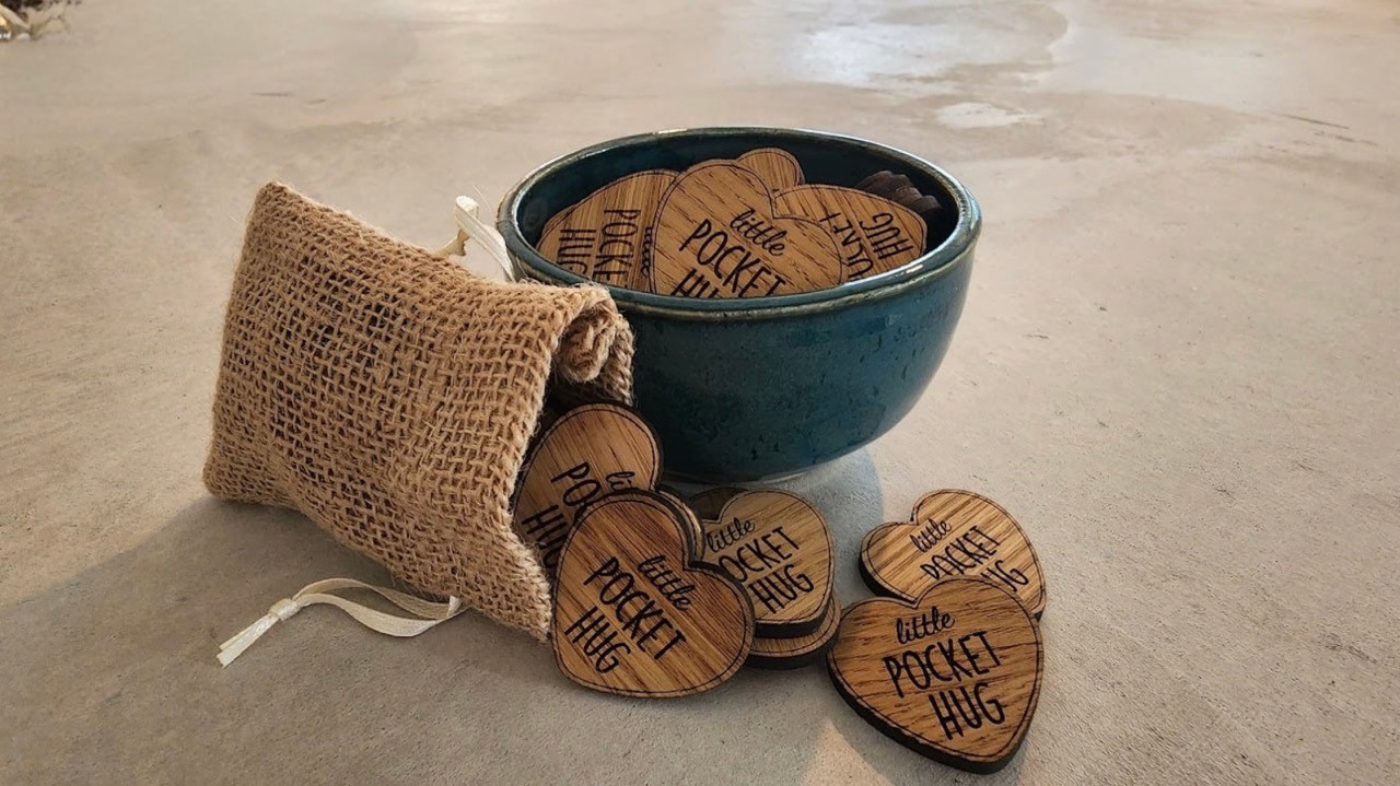 Wooden pocket hugs in burlap bag and ceramic bowl